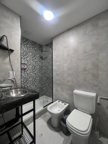 a bathroom with a toilet and a sink at Cozy Home Salta in Salta