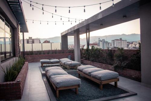 a row of mattresses on a balcony with a view of a city at Cozy Home Salta in Salta