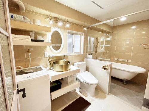 a bathroom with a sink and a toilet and a tub at Ocean Villa Tin Gala - Vacation STAY 98840v in Atsutabaru