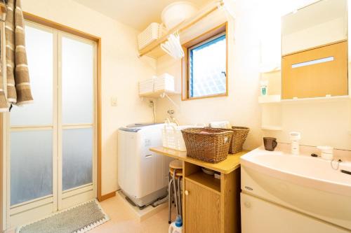 a bathroom with a sink and a washing machine at Hiei Blue Roof - Vacation STAY 13887 in Otsu
