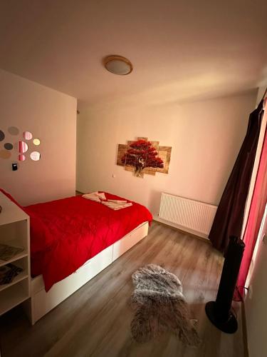 een slaapkamer met een rood bed en een rode deken bij Red Corner Central Apartment in Cluj-Napoca