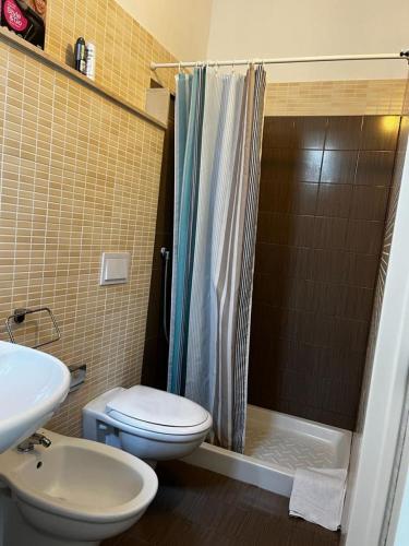 a bathroom with a shower and a toilet and a sink at La Dimora di Nonna Lucia in Polignano a Mare