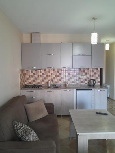 Una sala de estar con un sofá y una cocina. en Studio, en Angisa