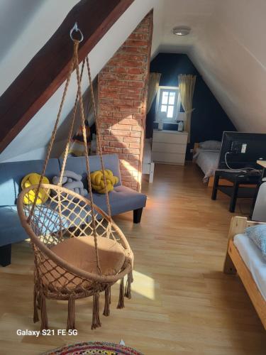a room with a hanging chair and a living room at Geräumige Wohnungen Zentrumsnah Schwandorf in Schwandorf in Bayern