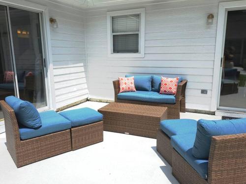 a patio with two cushioned chairs and a table at Close to the beach and attractions! Perfect for families or traveling nurses! in Wilmington