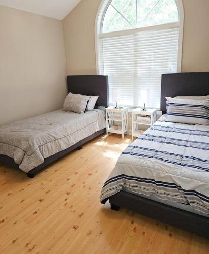 a bedroom with two beds and a window at Close to the beach and attractions! Perfect for families or traveling nurses! in Wilmington