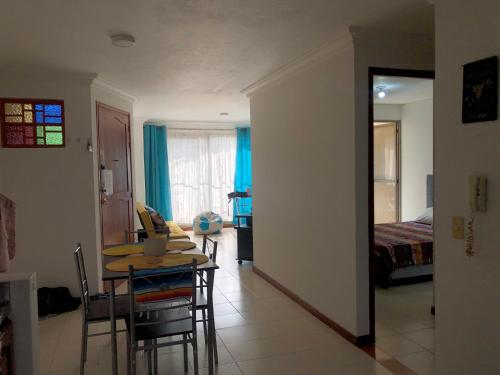 a living room with a table and a bedroom at Full Apartamento en Medellin Itagui Centro de la moda Mayorista Poblado in Itagüí