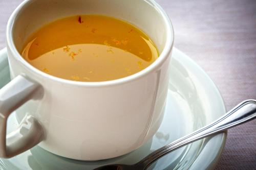 a cup of coffee on a plate with a spoon at Masseria Fortificata Lo Zafferaneto in Buccheri