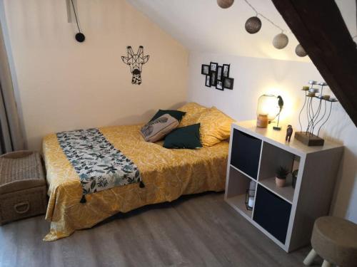 a bedroom with a bed and a dresser in it at Studio proche zoo de la Flèche in La Flèche