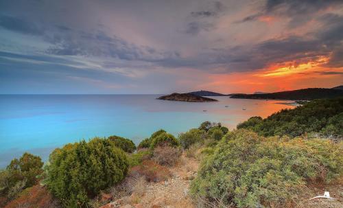 an island in the ocean with a sunset in the background at Villa Alberta Hotel in Pula