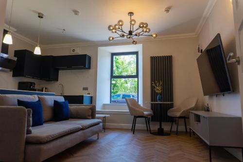 a living room with a couch and a table at Oban Apartments in Oban