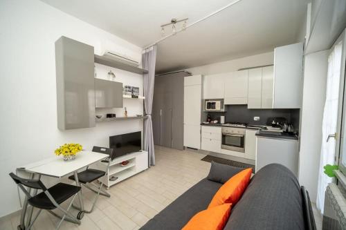 a kitchen and a living room with a couch and a table at Fiumicino Business&Vacation Apt Wifi in Fiumicino