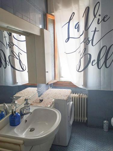 a bathroom with a sink and a toilet and a mirror at CRISTIN B&B in Monfalcone