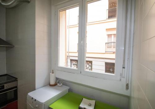 ein Badezimmer mit grünem Boden und einem Fenster in der Unterkunft Exclusivo y acogedor Apartamento en Chueca, Madrid con aire acondicionado in Madrid