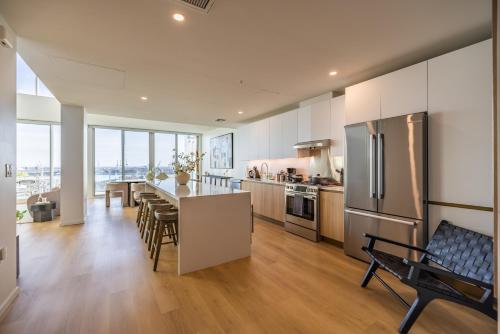 a large kitchen with a table and chairs in it at @ Marbella Lane - Penthouse w/ City & Ocean Views in Long Beach