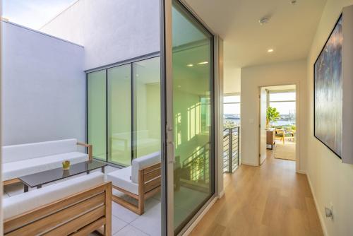 a room with glass walls and a hallway at @ Marbella Lane - Penthouse w/ City & Ocean Views in Long Beach