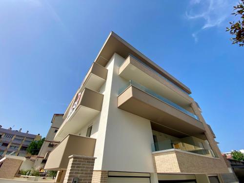 a white building with balconies on the side of it at Residence LeoMare in Martinsicuro