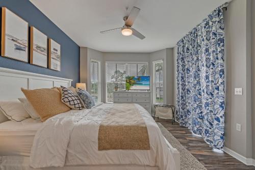 a bedroom with a bed and a tv in it at Golf Condo- Resort Pool- LakeView- 10mi to beaches in Naples