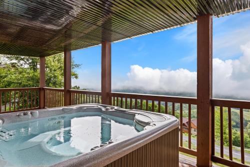 a hot tub on the deck of a house at Golden Ridge Getaway in Blowing Rock