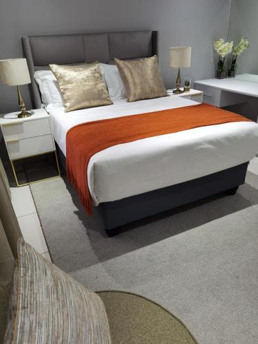 a bedroom with a large bed and two night stands at Kings View Exclusive Villas (KVEV) in Petronella