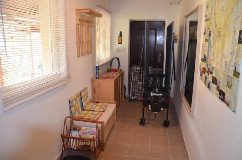 a hallway with a table and a chair in a room at Alföldi Vendégház in Hódmezővásárhely