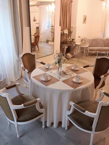 a white table and chairs in a living room at CASA BELGERI - Bed & Breakfast in Dongio