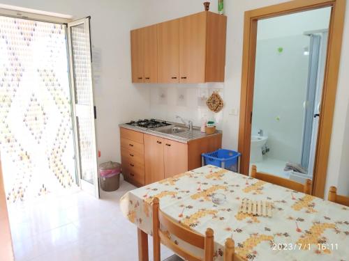 a kitchen with a table and a dining room at Villa Scialara in Vieste