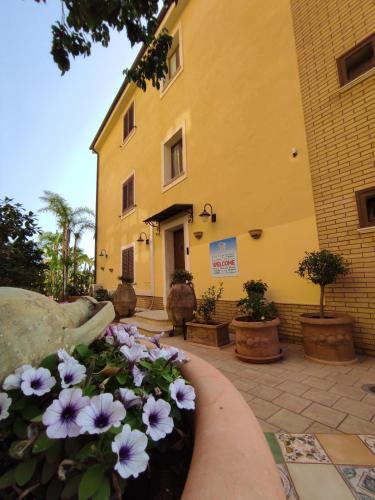 a building with a flower bed in front of it at B&B Villa Colomba in Agrigento