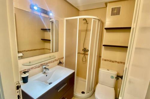 a bathroom with a sink and a toilet and a mirror at Bahia del cabo in Cabo Negro