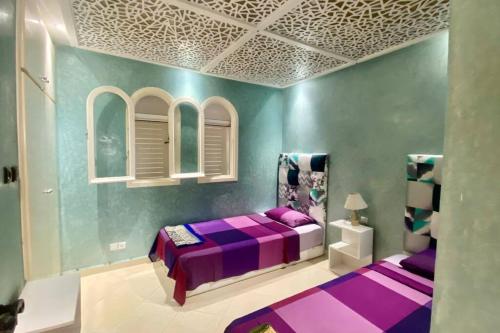 a purple bedroom with a purple bed in a room at Bahia del cabo in Cabo Negro