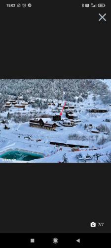 a view of a town with snow on the ground at Appartement T2 Guzet Neige in Ustou
