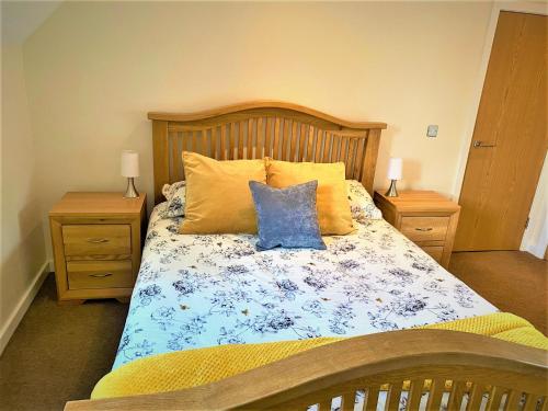 a bedroom with a bed with two night stands at ThreeStorey Townhouse - Free parking in Normanton
