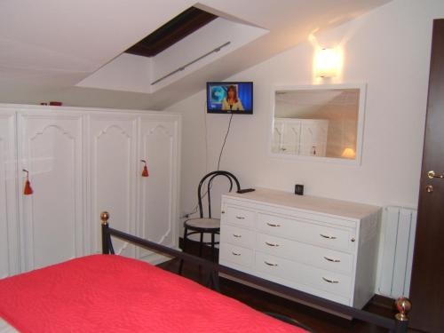 a bedroom with a white dresser and a red bed at Greatview Narni in Narni