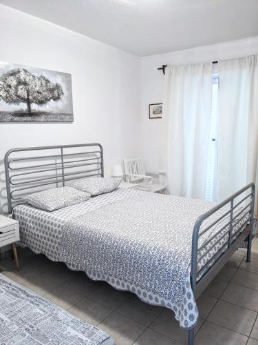 a bedroom with a bed and a window at Central Studio Apartments & Dormitory Rooms in Supetar