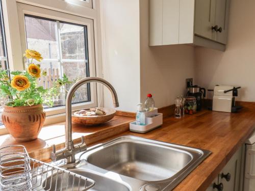 a kitchen counter with a sink and a window at 76 High Street in Redcar