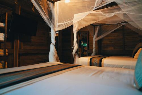 a bedroom with two beds in a room at Bluebayou Bacalar in Bacalar