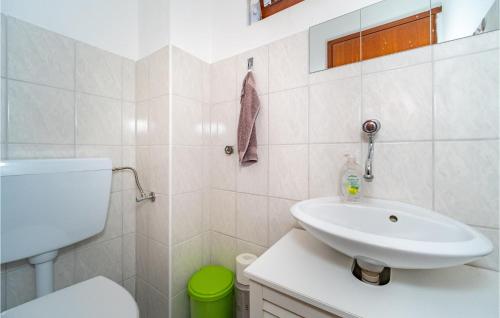 a white bathroom with a sink and a toilet at Amazing Home In Duga Resa With House A Panoramic View in Duga Resa