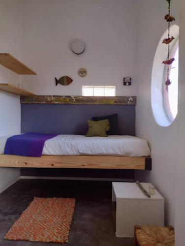 a bedroom with a bed with a blue wall at Trotamundos CASA in Puerto Pirámides