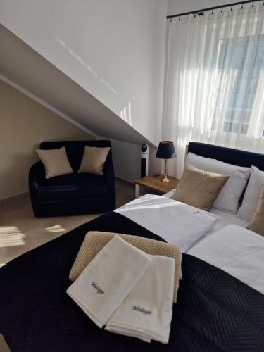 a bedroom with two beds and a couch at Apartamenty Malaga II in Darłowo