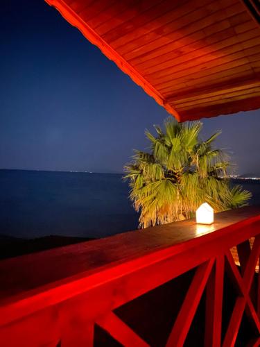 a view of the ocean from a deck at night at Lazoğlu Bungalov in Guzelcamlı