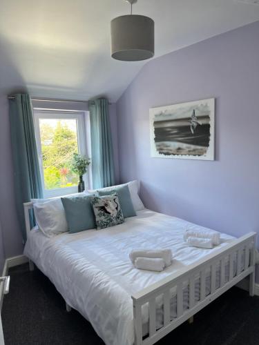 un letto bianco in una stanza con finestra di The Wedge a Southend-on-Sea