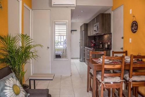 a kitchen and dining room with a table and chairs at Casa Girasol Tulum in Tulum