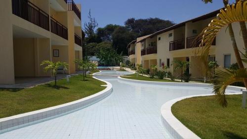 a swimming pool in front of a building at Solar Águas Pipa Prime in Pipa