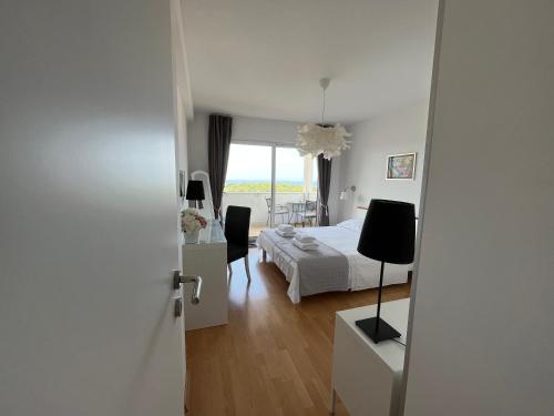 a bedroom with a bed and a table and chairs at La Fee studio apartment in Hvar