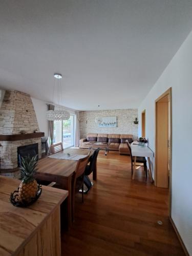 a living room with a table and a fireplace at Apartments Villa Sotlar with pool in Umag