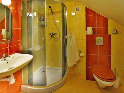 ein Bad mit einer Dusche, einem WC und einem Waschbecken in der Unterkunft Holiday house by the lake with a fireplace in Rosnowo
