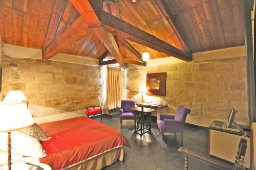 A bed or beds in a room at Posada Real Castillo del Buen Amor