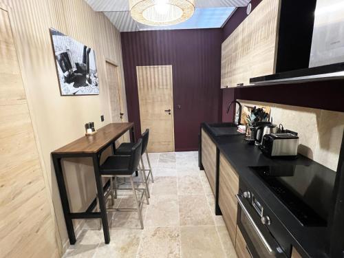 a kitchen with a counter and a table with chairs at LE PECHEUR DE CASSIS in Cassis