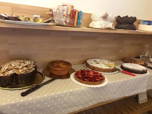 a table with cakes and other desserts on at B&B Indipendenza in Civitanova Marche