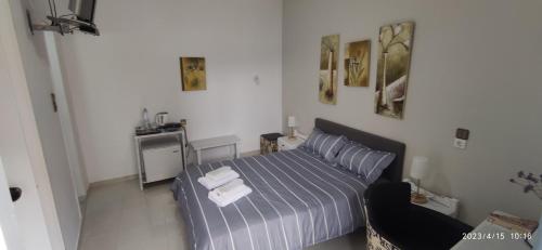a bedroom with a bed with two towels on it at ODYSSEAS HOTEL SAMOS in Samos